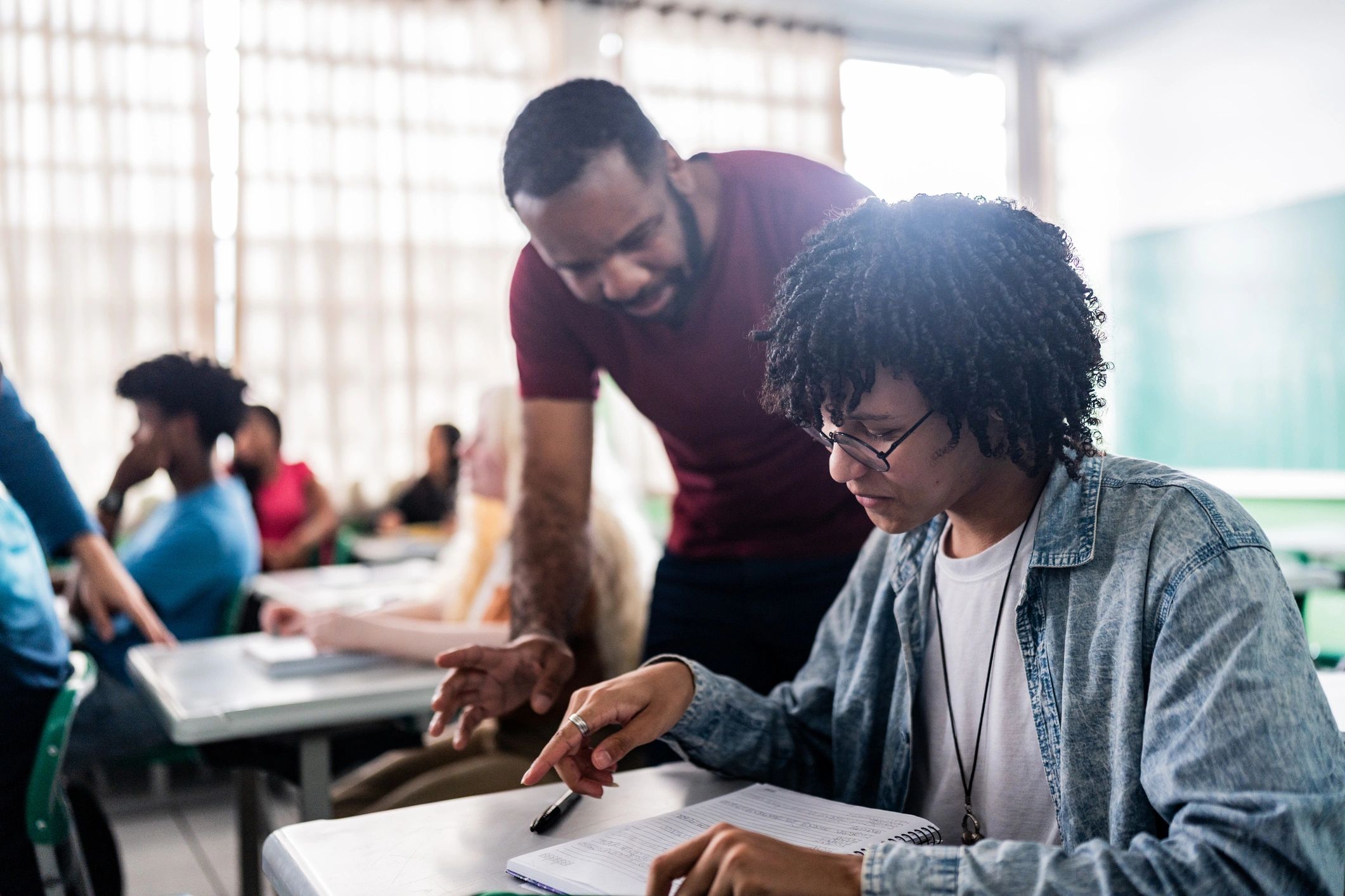 Teacher assisting a student in class