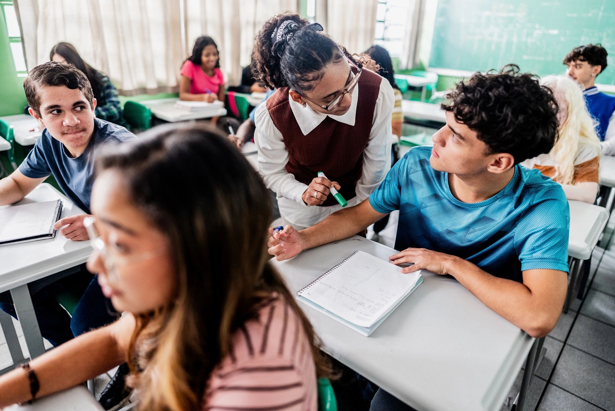 Teacher assisting a student during class